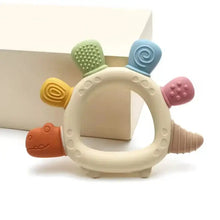 Anneau de dentition en silicone à reliefs pastel en forme de dinosaure avec appendices colorés en matière silicone