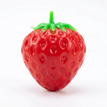 Balle sensorielle fraise rouge en plastique avec texture croquante et dessus feuillu vert à presser