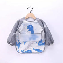 Bavoir tablier à manches longues bleu dinosaure avec manches rayées grises et poche transparente imperméable
