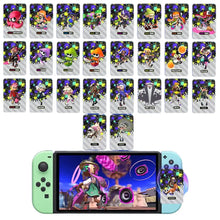 Cartes nfc splatoon 2026 avec manettes joy-con mint vert et bleu clair et cartes personnages colorées disposées dessus