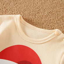 Combinaison bébé père noël crème avec grand motif circulaire rouge sur le devant pour occasions festives