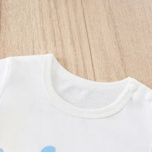 Combinaison bébé unisexe en coton blanc avec col rond et boutons pression blancs sur l’épaule