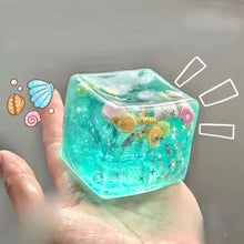 Cube anti stress translucide turquoise rempli de coquillages colorés étoiles de mer et étoiles pailletées jouets à presser