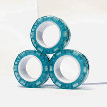 Lot de 3 anneaux magnétiques à manipuler translucides teal avec noyaux blancs et bord texturé segmenté