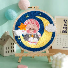 Kit de broderie punch needle avec motif décoratif d un personnage rose crocheté sur lune jaune dans ciel nocturne bleu