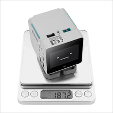 Robot de bureau m5stack stackchan esp32-s3 gris et teal avec écran affichant un smiley et ports latéraux