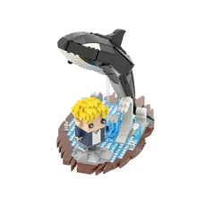 Jeu de construction orque avec une orque noir et blanc sautant au-dessus d un personnage jaune sur base rocheuse marine