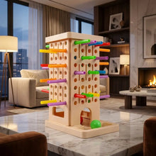 Jeu d’équilibre en plastique beige avec bâtonnets colorés et balle verte adapté aux tranches d’âge indiquées