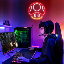 Enseigne néon led gaming en forme de champignon rouge et orange au-dessus d’un setup gaming contemporain