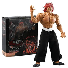 Figurine yujiro hanma musclée avec cheveux rouges en pics et pantalons noirs avec mains interchangeables à côté de son emballage