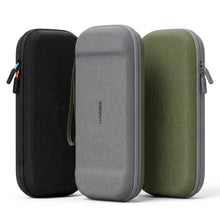 Trois housses rigides double face en noir gris et vert olive avec 10 emplacements pour jeux et zips assortis