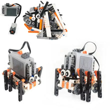Robot spider gris et orange en lego mindstorms avec jambes noires, yeux blancs et membres à engrenages pour construction robot spider électrique