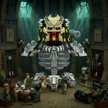 Lego moc alien predator figure with beige and black headpiece, yellow accents, sharp white teeth, and red eyes