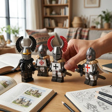 Un ensemble de quatre figurines lego moc médiévales en métal argenté avec armures noir et blanc et croix rouges et dorées