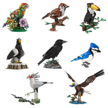 Colorful lego moc oiseaux with a vibrant red head and yellow beak among floral decorations from animaux volants collection