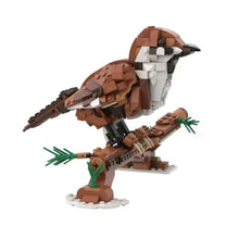 Lego moc oiseaux brown and white perched on branch with green foliage in lego moc animaux volants collection