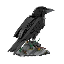 Lego moc oiseaux detailed black lego bird model with textured wings and rocky base featuring green foliage animaux volants