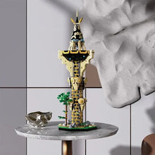 Modèle lego moc zelda tour sheikah en technic doré et noir avec détails mécaniques et arbre vert à la base