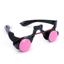 Lunettes halloween à yeux rouges lumineux avec monture plastique noire, verres circulaires roses et bande élastique rouge