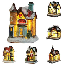 Maisonnette lumineuse de noël miniature à piles avec toit enneigé et nœud rouge éclairée chaleureusement