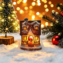 Maisonnette lumineuse de noël miniature à piles avec façade en briques marron et toit enneigé aux lumières chaudes