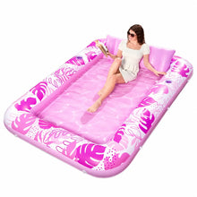 Matelas gonflable de piscine rose joyfy avec motif feuilles tropicales et oreillers intégrés pour confort optimal