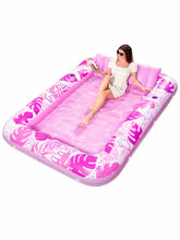 Matelas gonflable de piscine rose joyfy avec motif feuilles tropicales et coussins intégrés pour confort optimal