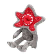 Peluche monstre fleur halloween grise avec tête rouge en forme detoile et dents blanches brodées