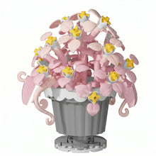 Nanoblock mini fleur en lego rose et jaune dans un pot gris avec bord crénelé, idéal magasins de jouets et déguisement carnaval