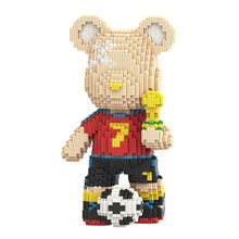 Ours décoratif beige en plastique abs construit avec petites briques portant un maillot rouge numéro 7 et tenant un trophée doré