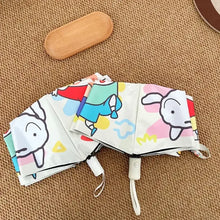 Parapluie automatique crayon shin-chan avec motifs multicolores sur fond clair et formes géométriques vives