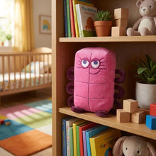 Peluche personnage chiffre rose en peluche avec membres violets et yeux brodés, forme rectangulaire unique