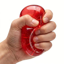 Pomme squishy souple rouge translucide avec paillettes tenue en main pour soulager le stress