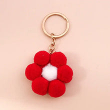 Porte-clés fleur tricotée rouge avec centre blanc et anneau métal doré en accessoire pratique et décoratif