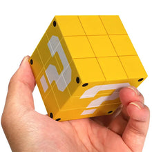 Bloc point d’interrogation rubik’s cube mario en plastique jaune avec point d’interrogation blanc et accents noirs aux coins
