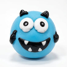 Squishy chien à visage interchangeable bleu vif avec cornes noires et large sourire denté pour adultes