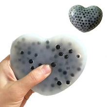 Gray squishy anti-stress cœur stress ball with black gel beads in translucent silicone for effective stress relief