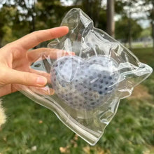 Squishy anti-stress cœur pession violet translucide texturé à pointillés en emballage plastique clair