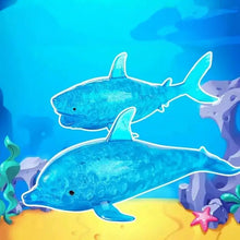Deux jouets squishy dauphin bleus translucides avec surface texturée billes gélifiées pour effet requin anti stress