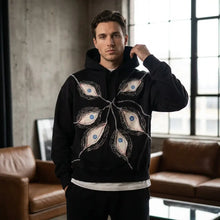 Sweat à capuche gothique noir à motifs yeux de paon stylisés bleus avec coupe ample et contours blancs