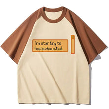 Cream-colored raglan t-shirt with brown sleeves and collar featuring pixelated text for stardew valley fans