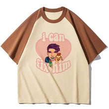 Cream-colored raglan t-shirt with brown sleeves and pixel-art smiling man holding chicken with i can fix him text stardew valley
