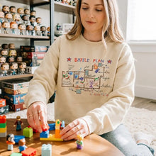 Sweatshirt unisexe couleur crème en coton avec motif battle plan dessiné à la main et illustrations colorées