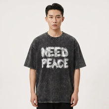 Black distressed coton t-shirt need peace with bold white spray-painted graphic for casual wear