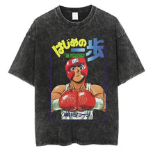 T-shirt manga club en coton noir délavé avec graphisme vibrant d’un personnage d’anime boxeur en rouge et texte japonais jaune et bleu