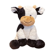 Vache en peluche douce noire et blanche avec un museau beige, compagnon sourire idéal à câliner assise droite